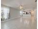 Open-concept living room with tile floors and bright white trim seamlessly connects to the kitchen at 4480 Turnberry Ln, Lake Wales, FL 33859