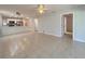 Open-concept living area with tile floors, and a view into the bright, white kitchen area at 4480 Turnberry Ln, Lake Wales, FL 33859