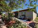 Charming patio with brick pavers, lush landscaping, and a cozy seating area, perfect for outdoor relaxation at 4480 Turnberry Ln, Lake Wales, FL 33859