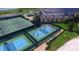 An aerial view showcasing pickleball courts with players enjoying the game, along with tennis courts nearby at 4480 Turnberry Ln, Lake Wales, FL 33859