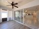Bright sun room transitioning to an open kitchen with white cabinetry and stainless steel appliances at 4480 Turnberry Ln, Lake Wales, FL 33859