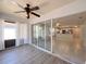 Bright sun room transitioning to an open kitchen with white cabinetry and stainless steel appliances at 4480 Turnberry Ln, Lake Wales, FL 33859