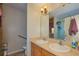 Bright bathroom featuring double sinks and a shower behind glass doors, adding a touch of elegance at 4703 Benton St, Lake Wales, FL 33859