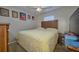 This is a simple bedroom with a simple bed, carpet, and decorations on the walls at 4703 Benton St, Lake Wales, FL 33859