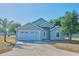 Charming single-story home with a two-car garage, lush landscaping, and a well-maintained front yard at 4703 Benton St, Lake Wales, FL 33859