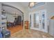 Inviting foyer featuring tile flooring, decorative front doors, and an arched doorway leading to other rooms at 4703 Benton St, Lake Wales, FL 33859