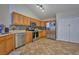 Well-lit kitchen boasts stainless steel appliances, tiled backsplash, tile flooring, and ample cabinet space at 4703 Benton St, Lake Wales, FL 33859