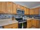 Close-up of the kitchen highlights stainless steel appliances and tile backsplash at 4703 Benton St, Lake Wales, FL 33859
