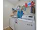 Functional laundry room equipped with modern washer and dryer, complemented by ample storage shelving at 4703 Benton St, Lake Wales, FL 33859