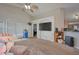 Comfortable living room featuring plush carpeting, a ceiling fan, and an open layout perfect for entertaining at 4703 Benton St, Lake Wales, FL 33859