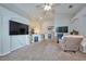 Bright and airy living room with plush carpeting, ceiling fan, and open floor plan at 4703 Benton St, Lake Wales, FL 33859