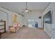 Cozy living room featuring plush carpeting, ceiling fan, and sliding glass doors leading to the outside at 4703 Benton St, Lake Wales, FL 33859