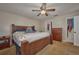 This is a cozy main bedroom with a ceiling fan, closet, dresser and wooden bed frame at 4703 Benton St, Lake Wales, FL 33859
