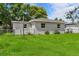 Exterior view showcasing a well-maintained yard and updated windows for energy efficiency at 4760 Holton Rd, Auburndale, FL 33823