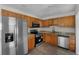 Modern kitchen with stainless steel refrigerator and black gas range at 4760 Holton Rd, Auburndale, FL 33823