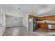 Bright kitchen featuring stainless steel appliances and warm wood cabinetry at 4760 Holton Rd, Auburndale, FL 33823