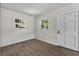 Bright and airy room with new flooring, fresh paint, and a modern door at 4760 Holton Rd, Auburndale, FL 33823