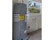 AO Smith water heater near window installed on concrete perimeter wall and wood floor at 4760 Holton Rd, Auburndale, FL 33823