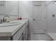 Bright bathroom featuring double sinks, white cabinets, and a walk-in shower at 500 Rio Grande Dr, Kissimmee, FL 34759