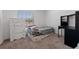 Bedroom with a daybed, white dresser, and a black desk at 500 Rio Grande Dr, Kissimmee, FL 34759