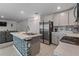 Bright kitchen with a central island, stainless steel appliances, and ample cabinet space at 500 Rio Grande Dr, Kissimmee, FL 34759
