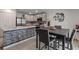 Well-lit kitchen featuring a breakfast bar, stainless steel appliances, and a dining area with seating at 500 Rio Grande Dr, Kissimmee, FL 34759