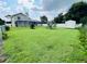 Large backyard with screen enclosed patio, privacy fence, and mature landscaping at 502 Little Lake Ct, Winter Haven, FL 33884