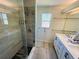 Modern bathroom featuring a glass-enclosed shower and dual vanity at 502 Little Lake Ct, Winter Haven, FL 33884