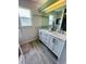 Bathroom featuring a double vanity with a large mirror and wood-look flooring at 502 Little Lake Ct, Winter Haven, FL 33884