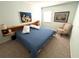 Comfortable bedroom with a blue quilt bedspread and unique wooden headboard at 502 Little Lake Ct, Winter Haven, FL 33884