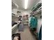 Walk-in closet with metal shelving for clothing and storage at 502 Little Lake Ct, Winter Haven, FL 33884