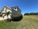 Side yard featuring mature landscaping and well maintained lawn at 502 Little Lake Ct, Winter Haven, FL 33884