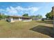 Lush backyard featuring green grass and mature trees, perfect for outdoor activities at 5829 Lake Breeze Ave, Lakeland, FL 33809