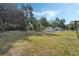Spacious backyard featuring mature trees, providing a serene and private outdoor space at 5829 Lake Breeze Ave, Lakeland, FL 33809