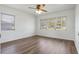 Bright bedroom featuring wood floors, neutral walls, and a ceiling fan for a modern, airy feel at 5829 Lake Breeze Ave, Lakeland, FL 33809