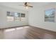 Well-lit bedroom with three windows, modern flooring, and neutral decor at 5829 Lake Breeze Ave, Lakeland, FL 33809