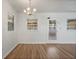 Bright dining area with white paneled walls, modern floors, and a stylish chandelier at 5829 Lake Breeze Ave, Lakeland, FL 33809