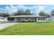 Charming single-story home featuring a lush lawn and an inviting carport at 5829 Lake Breeze Ave, Lakeland, FL 33809