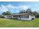 Charming single-story home with well-maintained lawn and covered carport at 5829 Lake Breeze Ave, Lakeland, FL 33809
