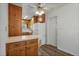 Traditional kitchen with wooden cabinets, white appliances, and a ceiling fan with lights at 5829 Lake Breeze Ave, Lakeland, FL 33809