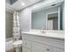 Bright bathroom featuring a single sink vanity with white cabinets and a shower with a decorative curtain at 6014 Crystal View Dr, Orlando, FL 32819