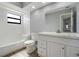 Clean bathroom featuring a white vanity, toilet, and tub-shower combo with bright window at 6014 Crystal View Dr, Orlando, FL 32819