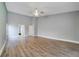 Expansive bedroom with wood-look flooring, a ceiling fan, and access to the bathroom and hallway at 6014 Crystal View Dr, Orlando, FL 32819