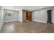 Spacious bedroom featuring wood flooring, a large window, and a custom closet with sliding barn doors at 6014 Crystal View Dr, Orlando, FL 32819
