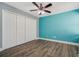 Comfortable bedroom with a ceiling fan, wood-look floors, and a closet at 6014 Crystal View Dr, Orlando, FL 32819