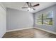 Neutral bedroom features a ceiling fan, and a large window with great light at 6014 Crystal View Dr, Orlando, FL 32819