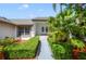 Charming home entrance with decorative landscaping, sculpted hedges, and a symmetrical walkway at 6014 Crystal View Dr, Orlando, FL 32819