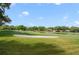 Picturesque golf course featuring a sand trap and waterfront homes in the distance at 6014 Crystal View Dr, Orlando, FL 32819