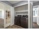 Laundry room featuring washer and dryer and storage cabinets with easy access to the bathroom and bedroom at 6014 Crystal View Dr, Orlando, FL 32819