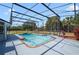 Screened in pool with clear water, surrounding deck, mature landscaping, and a view of the yard at 6014 Crystal View Dr, Orlando, FL 32819